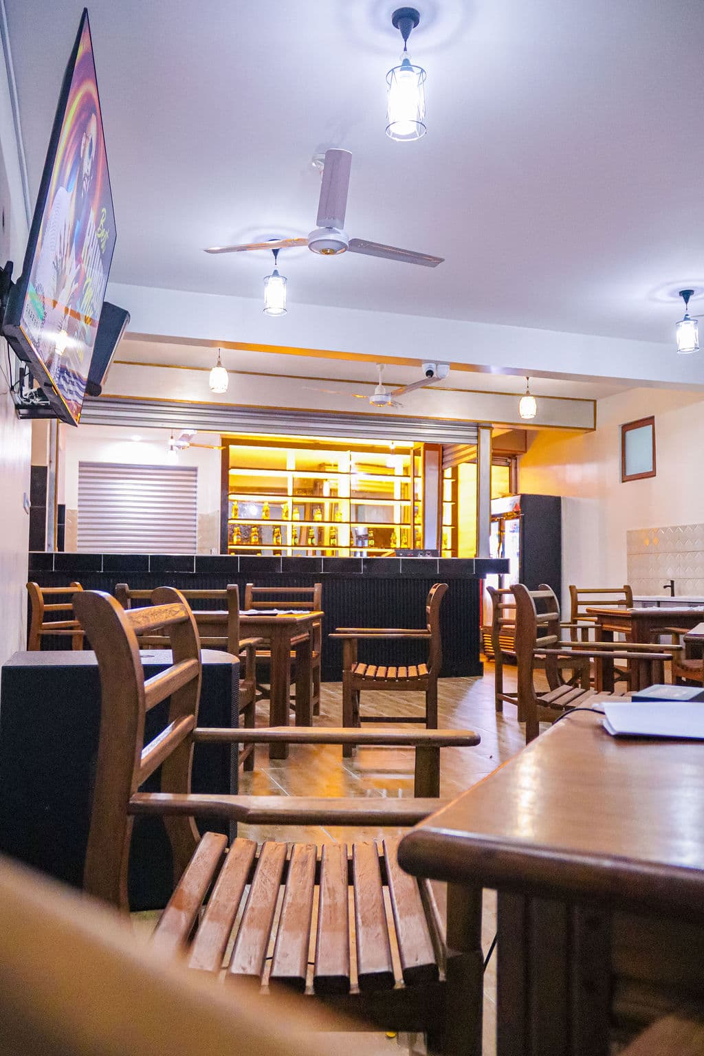 Restaurant seating looking toward the warmly lit bar